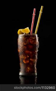 Glass cola with ice and straw. Cold glass of cola with lemon.