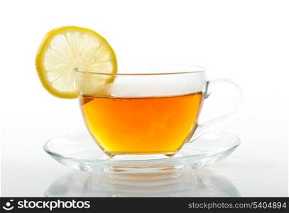 Glass cup of black tea with slice of lemon isolated on white