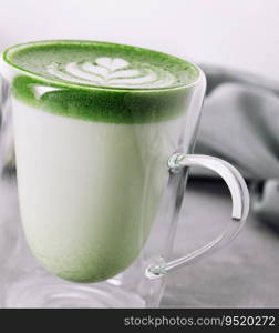 glass cup of fresh matcha latte closeup