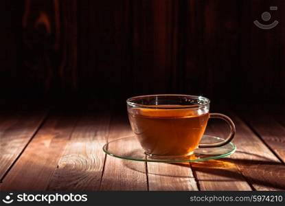 Glass cup of tea on a wooden table. Glass cup of tea