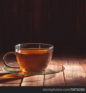 Glass cup of tea on a wooden table. Glass cup of tea