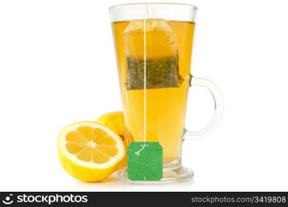 Glass cup of tea with lemon on a white background