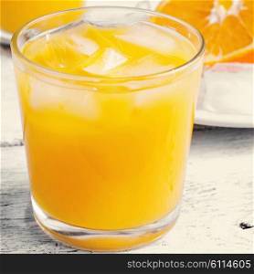 Glass cup with fresh orange juice vitamin.Photo tinted. fresh orange juice