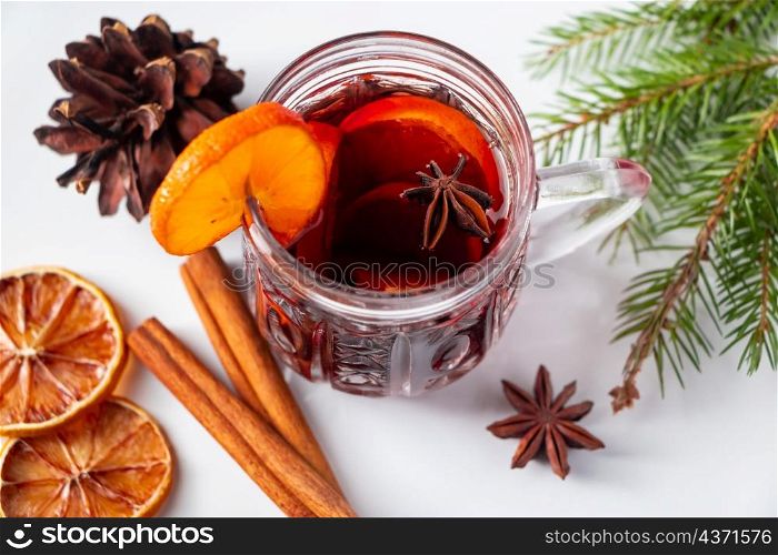 Glass cup with mulled wine on a white background. Winter warming drink.. Glass cup with mulled wine on white background. Winter warming drink.