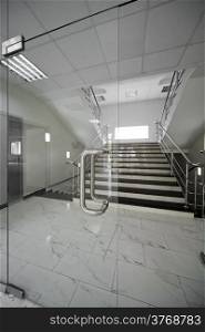 Glass doors with a kind on a marble staircase