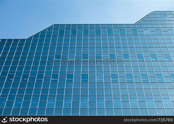 Glass facade modern office building with blue sky in Dutch city Utrecht. Glass facade modern office building in Dutch city Utrecht