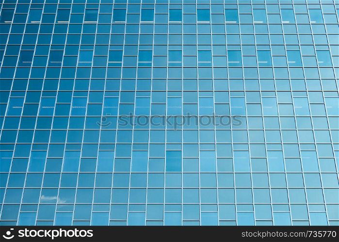 Glass facade modern office building with reflection blue sky in Dutch city Utrecht. Glass facade modern office building in Dutch city Utrecht