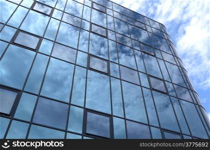 Glass facade of an office building with reflection of clouds in Rijswijk, Netherlands.