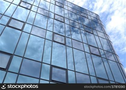 Glass facade of an office building with reflection of clouds in Rijswijk, Netherlands.