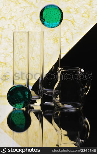 Glass glasses and jug on a multi-coloured background