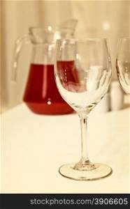 glass goblet and red beverage on the table