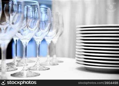 glass goblets and plates on the table