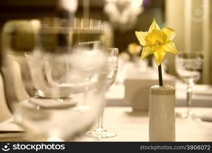 Glass goblets with flower on the table