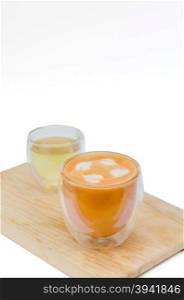 Glass hot thai tea cup. Glass hot thai tea cup with white foam surface and hot tea