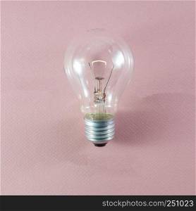 Glass incandescent tungsten filament light bulb being replaced due to energy consumption considerations