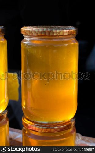 Glass jar of full of fresh honey with lid