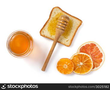 glass jar of honey and bread isolated on white