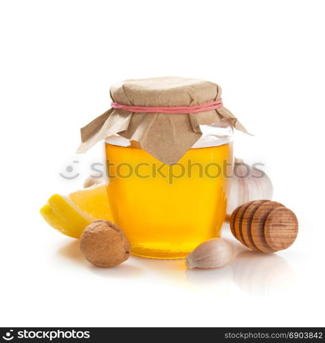 glass jar of honey isolated on white background