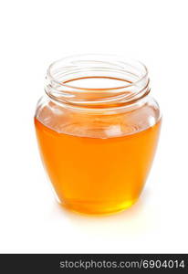 glass jar of honey isolated on white background