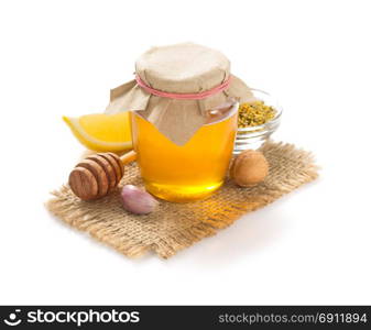 glass jar of honey isolated on white background