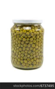 Glass jar of preserved peas on white background