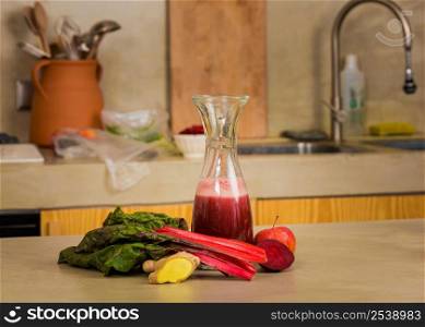 Glass jar of red juice, a detox beverage.