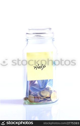 Glass jar with coins isolated on white background and word help.