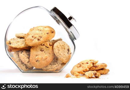 Glass jar with cookies against a white background