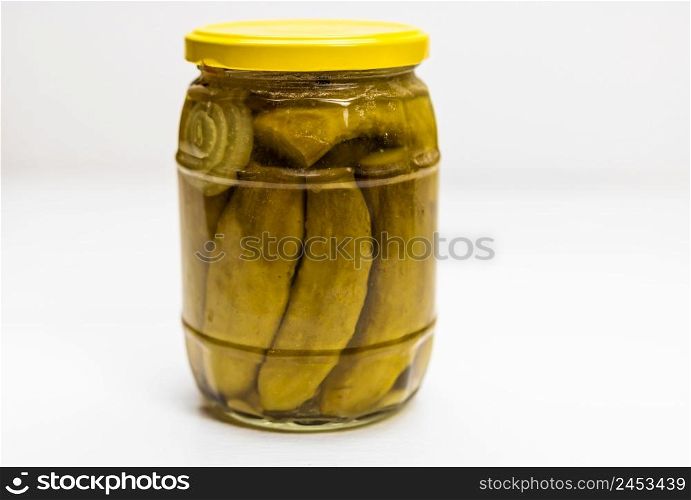 Glass jar with pickles isolated. Close up of pickled cucumbers.