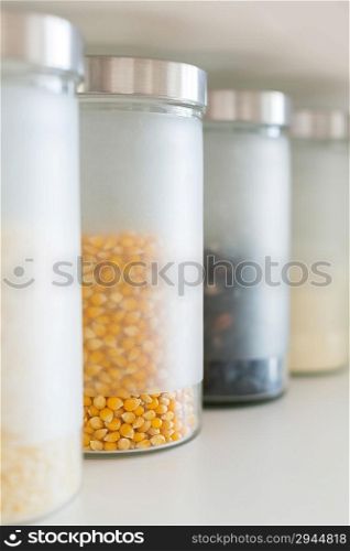 glass jars with grain on the shelf