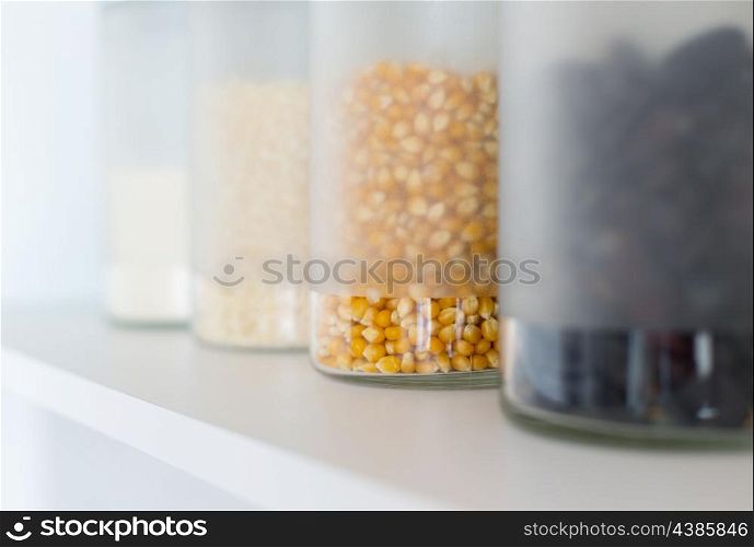 glass jars with grain on the shelf
