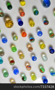 Glass marble balls and shadows on table