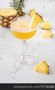 Glass of Algonquin cocktail garnished with pineapple slice