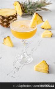 Glass of Algonquin cocktail garnished with pineapple slice