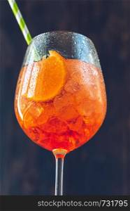 Glass of Aperol Spritz cocktail on the rustic background
