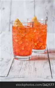 Glass of Aperol Spritz cocktail on the white wooden background