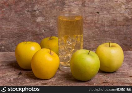 Glass of apple juice and fruits on a old wooden background