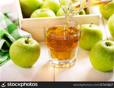 glass of apple juice with fresh fruits on wooden table