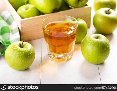 glass of apple juice with fresh fruits on wooden table