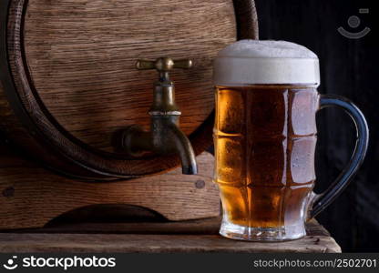 Glass of beer and vintage beer barrel still life