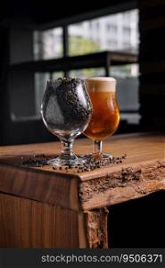 glass of beer and wheat in glass on wooden table