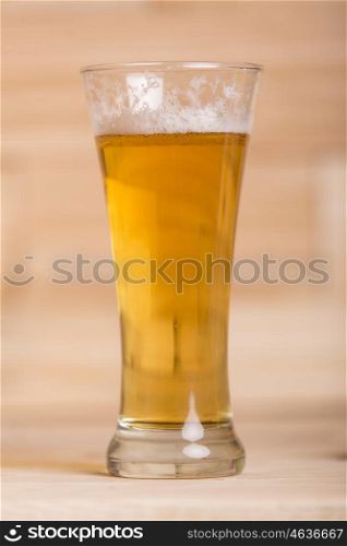 Glass of beer on wood background
