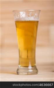 Glass of beer on wood background