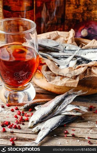 Glass of beer,smoked sprat,spices in traditional rustic style