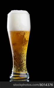 Glass of beer with froth over black background&#xA;