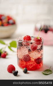 Glass of berry cocktail or drink soda with fresh berries on white background. Glass of berry cocktail