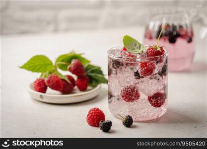 Glass of berry cocktail or drink soda with fresh berries on white background. Glass of berry cocktail