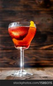 Glass of Boulevardier cocktail on wooen background