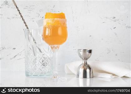 Glass of Brandy Crusta cocktail garnished with orange zest