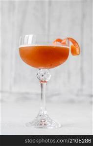 Glass of Brown Derby cocktail garnished with grapefruit zest twist